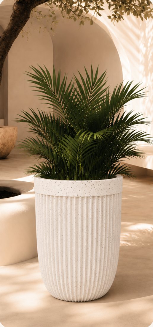 Aura vertical ribbed planter in white with a palm